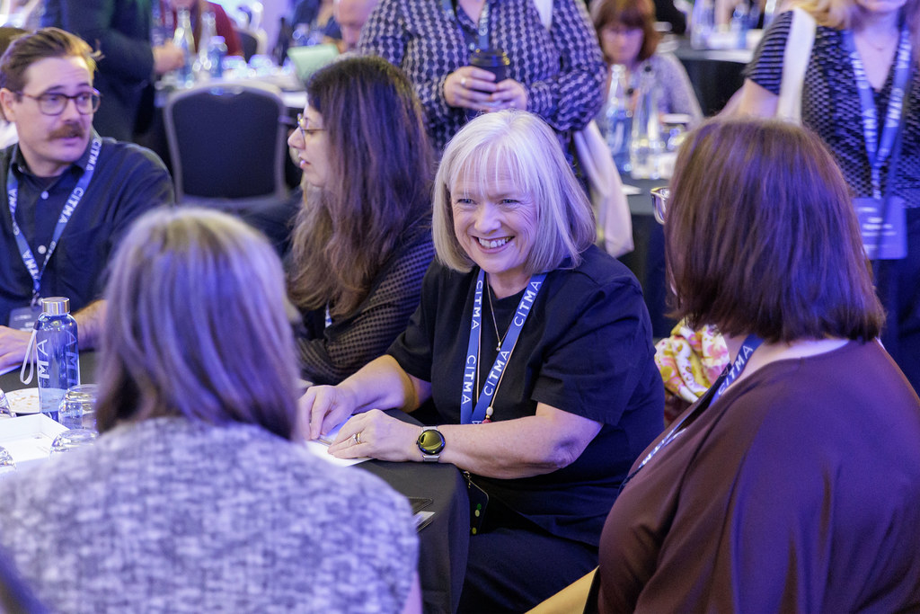 PC26 woman smiling at table.jpg