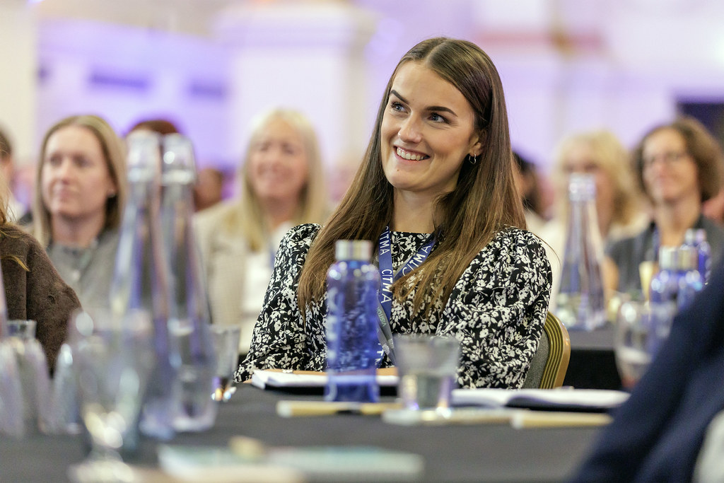 PC25 delegate smiling at table.jpg 1