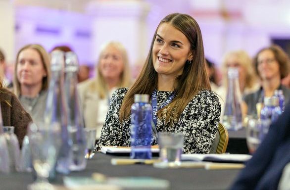 PC25 delegate smiling at table.jpg 1