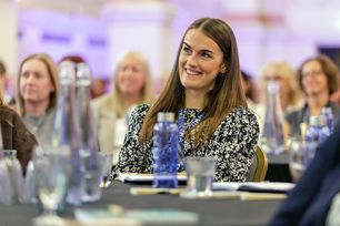 PC25 delegate smiling at table.jpg 1