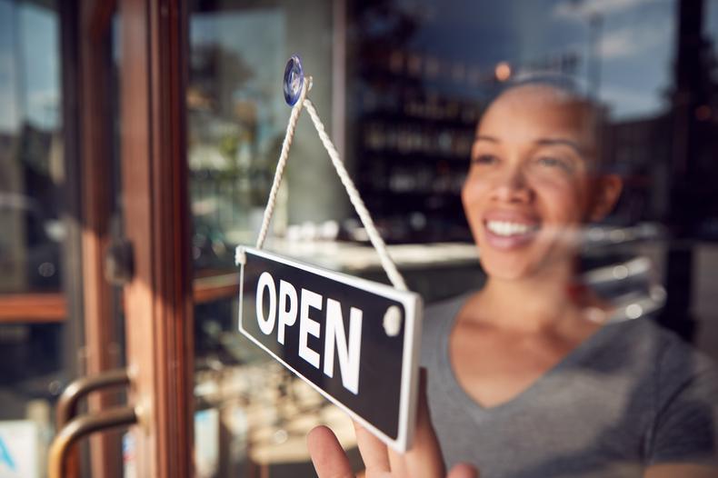 woman opening shop