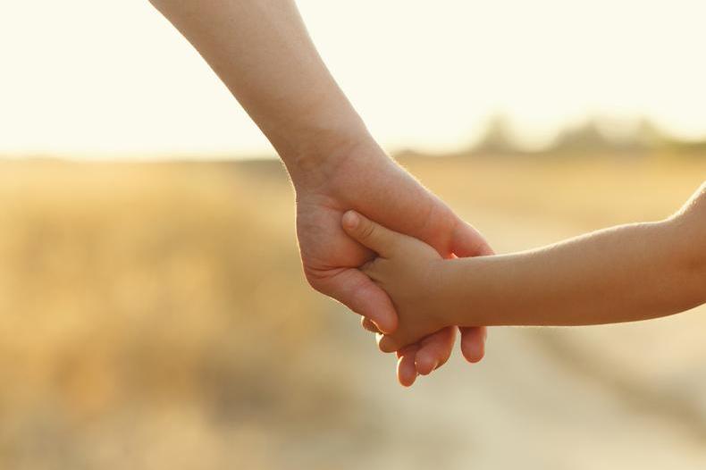 Picture of an adult holding a child's hand