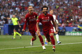 image of two Liverpool players running across a pitch, celebrating