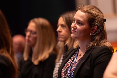 AC24 woman in crowd listening.jpg