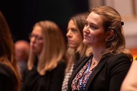 AC24 woman in crowd listening.jpg