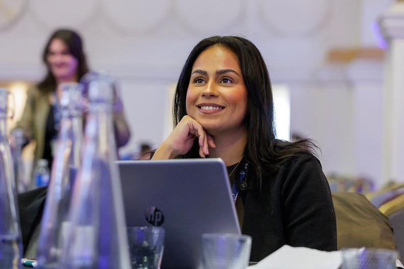 PC25 delegate with laptop smiling.jpg
